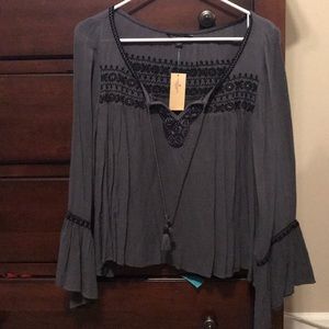 Grey blouse with tassels